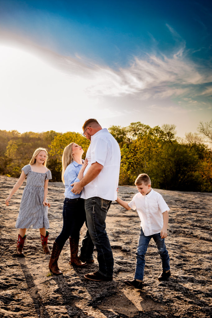 A family playing games and having fun during their photography session, showcasing genuine smiles and interactions