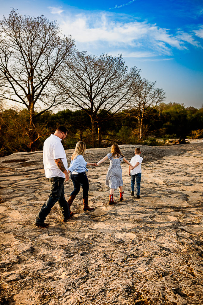 A family walking together in a zig-zag line.