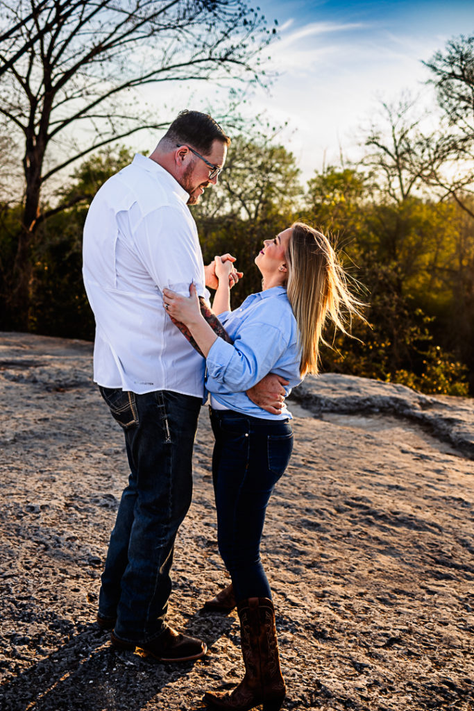 A couple dancing together while looking into each others eyes.