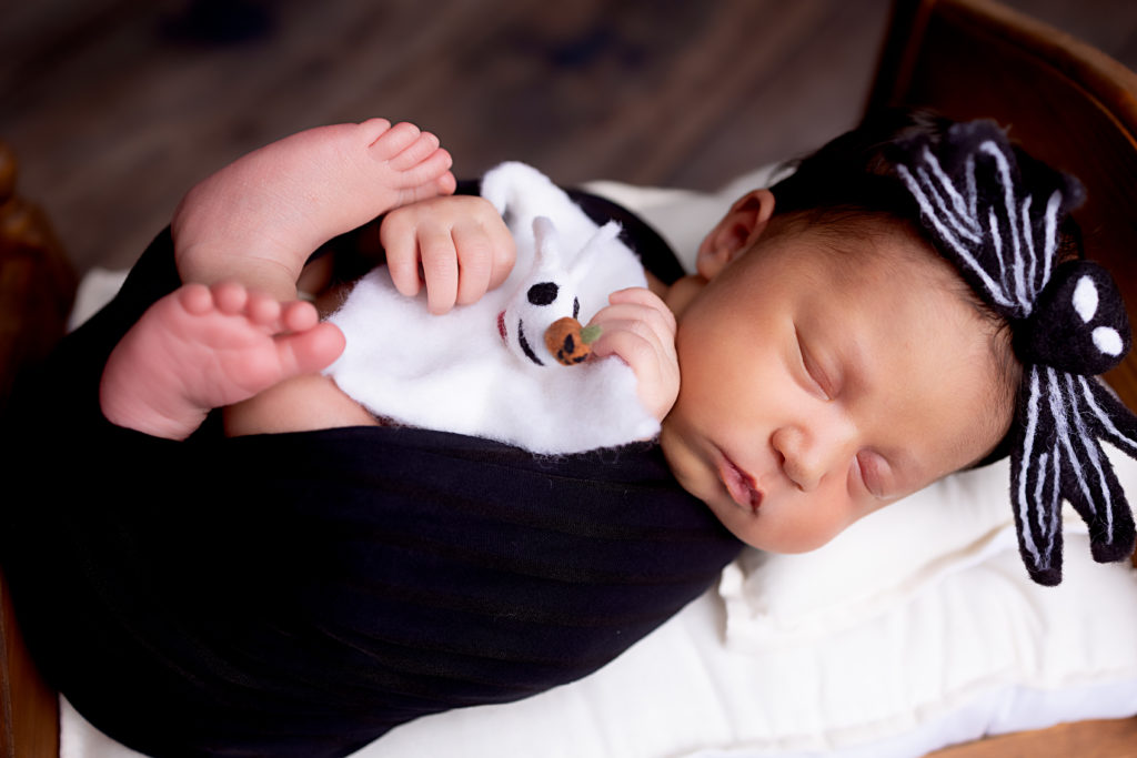 A baby girl with nightmare before Christmas stuffy and headband.