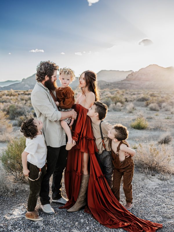 A stylish family dressed in coordinated outfits for their photo session, highlighting their unique personalities