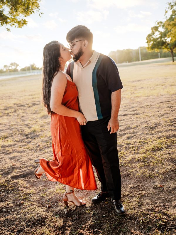 A husband and wife kissing.