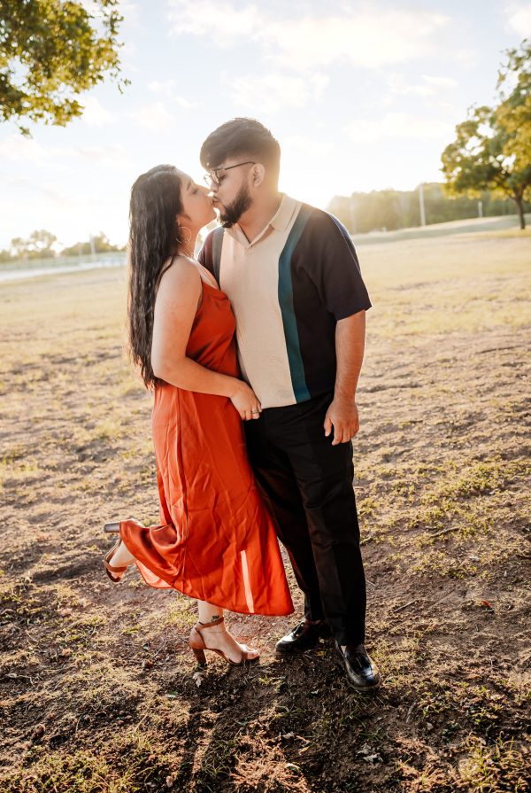 A husband and wife kissing.